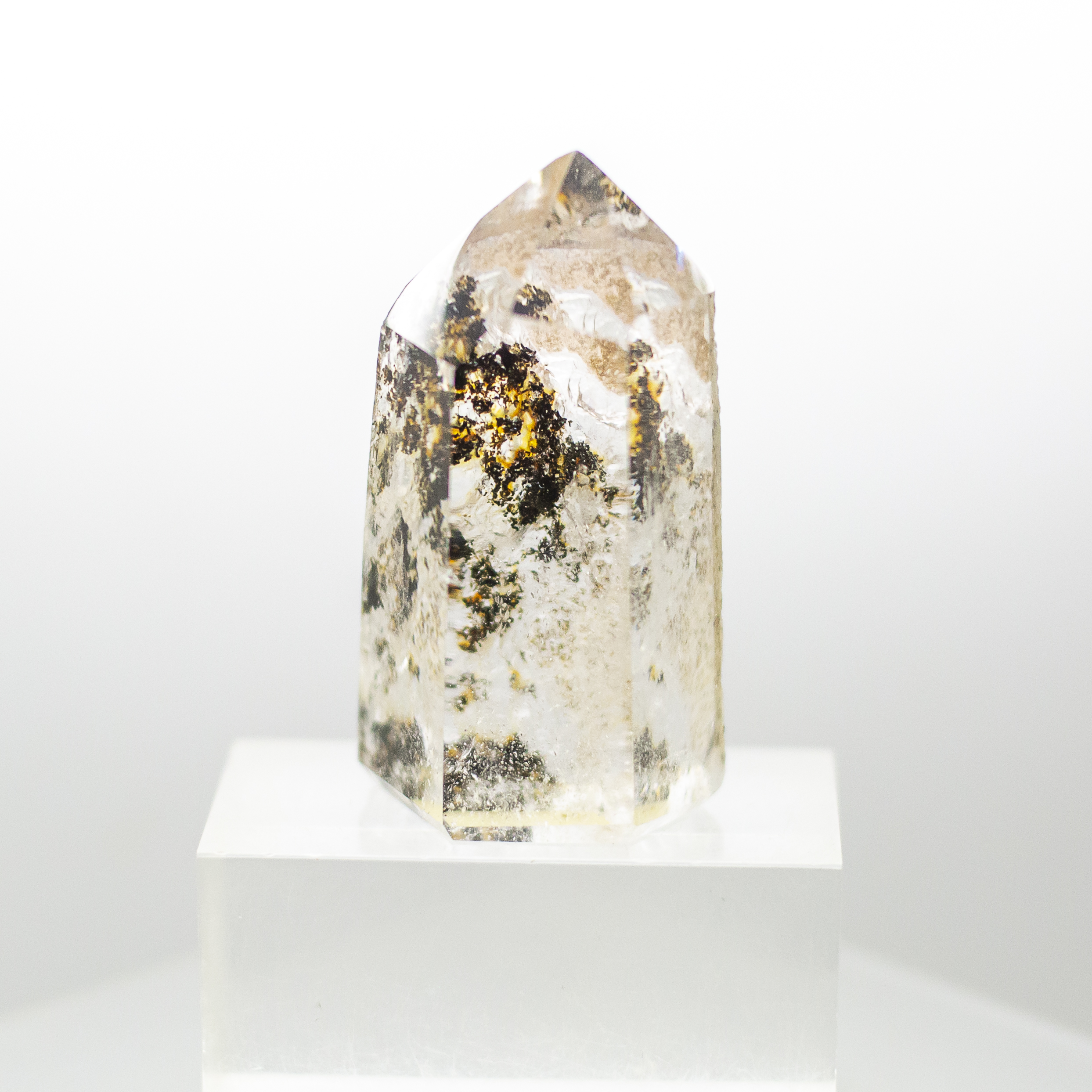 quartz point with inclusions