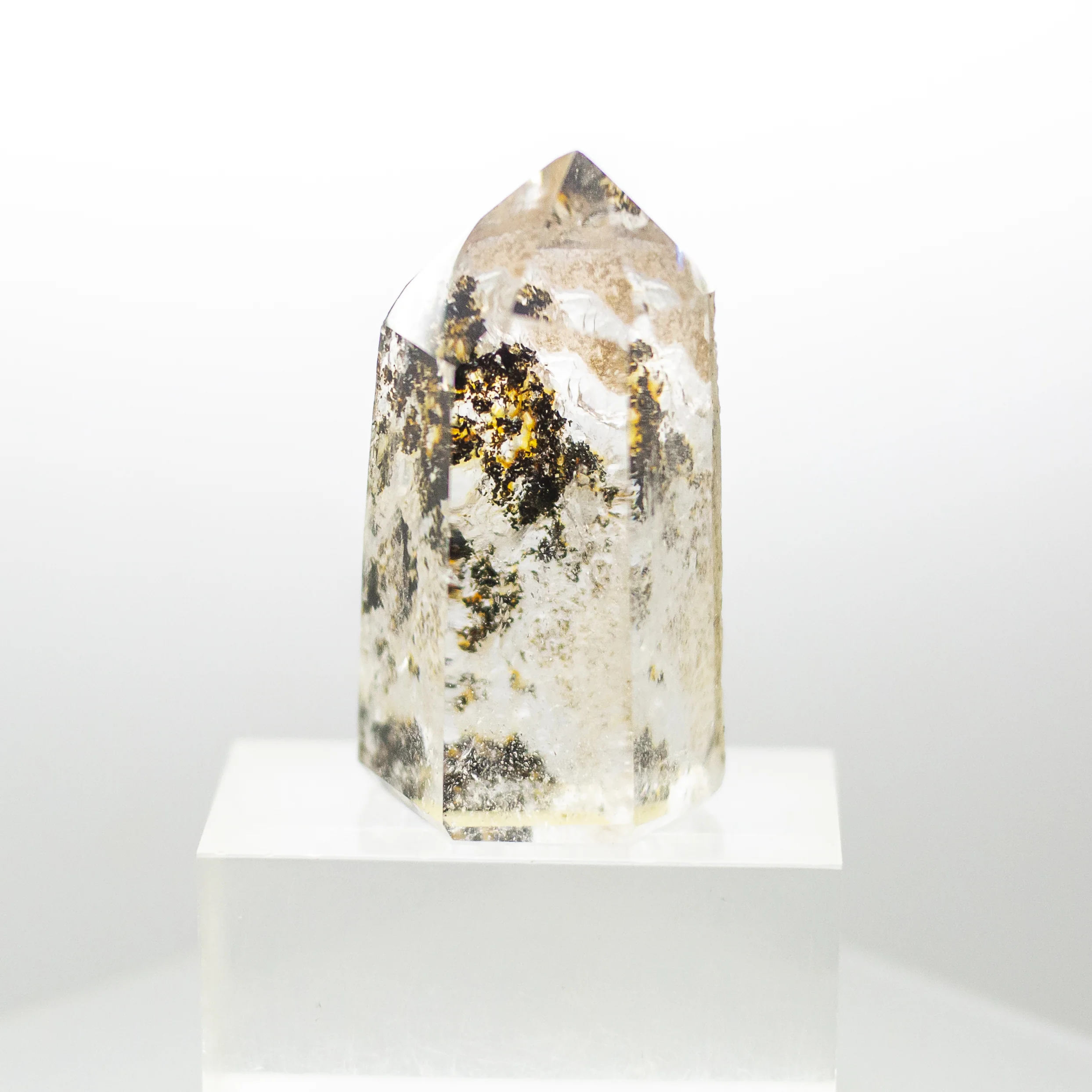 quartz point with inclusions